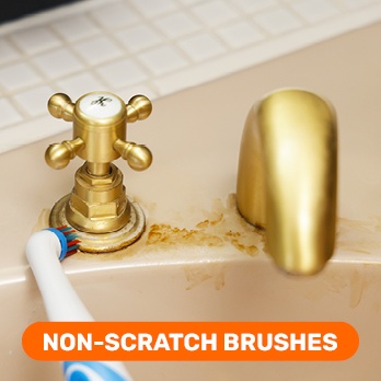 Using Easy Clean 360’s non-scratch brushes to clean a tap in the bathroom.